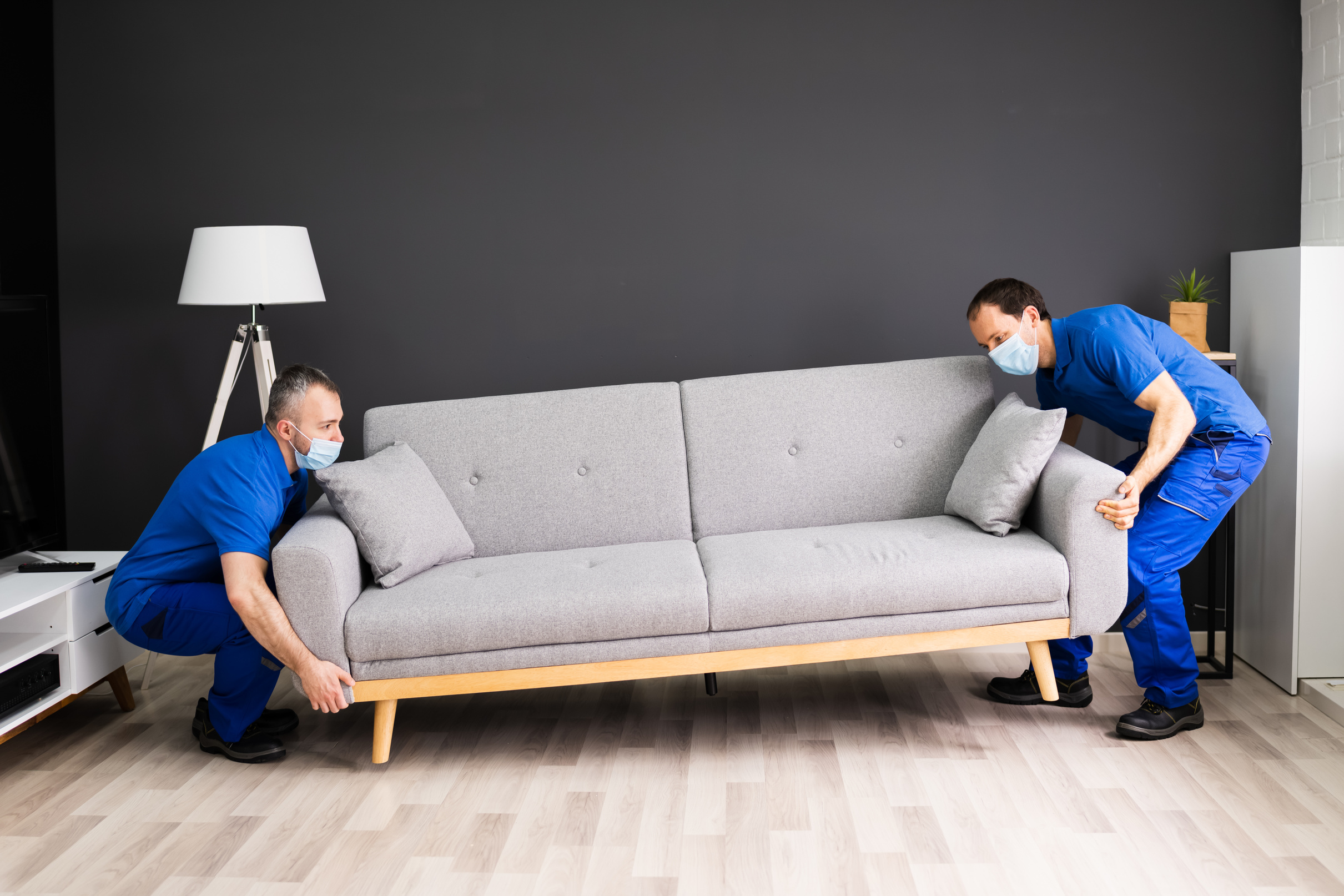 Professional Movers Moving Couch Furniture